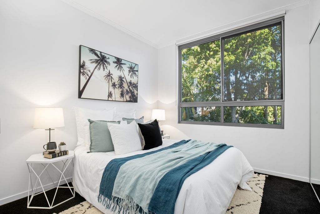 A bedroom with a large bed and a large window