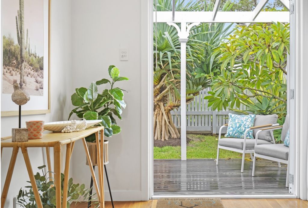 A living room with a sliding glass door leading to a patio.