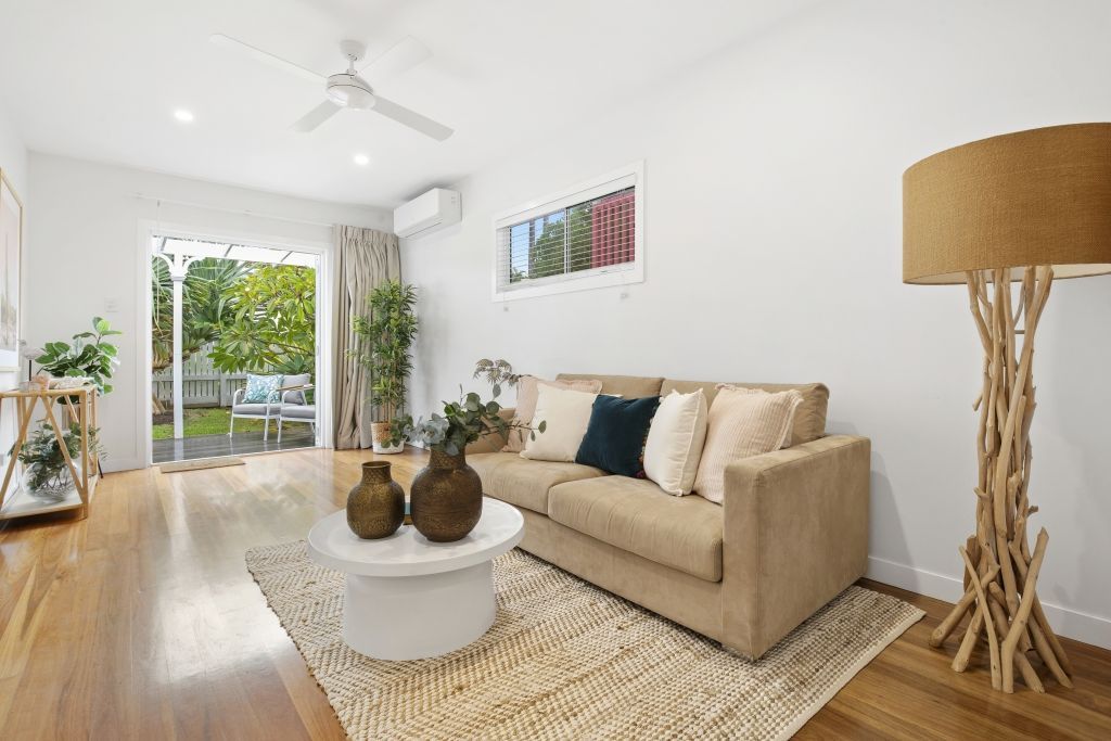 A living room with a couch , table and lamp.