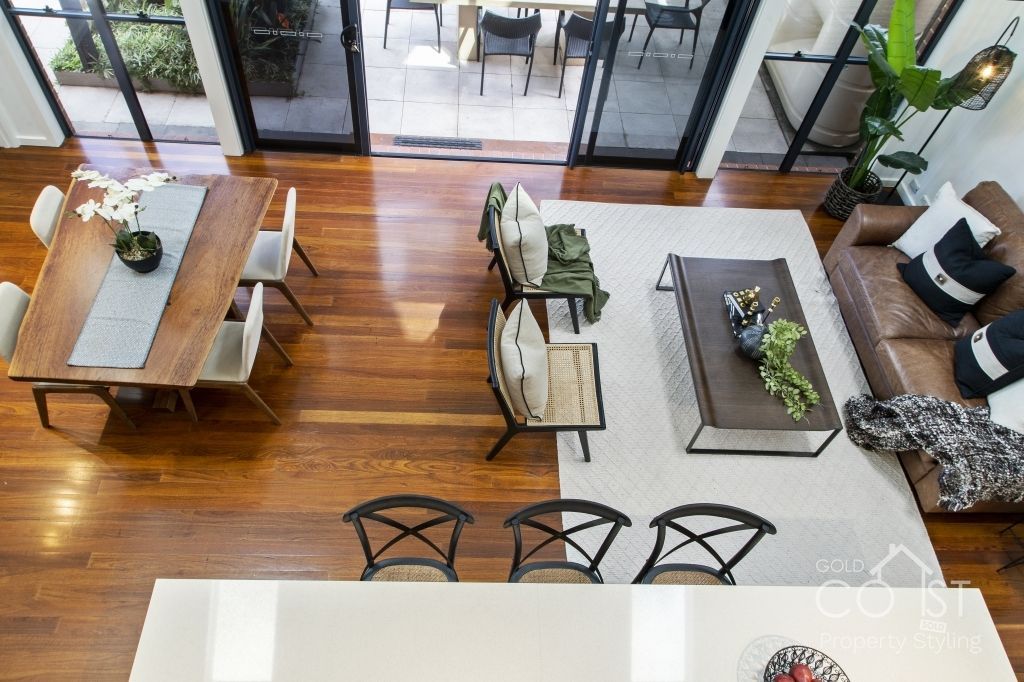 An aerial view of a living room and dining room in a house.