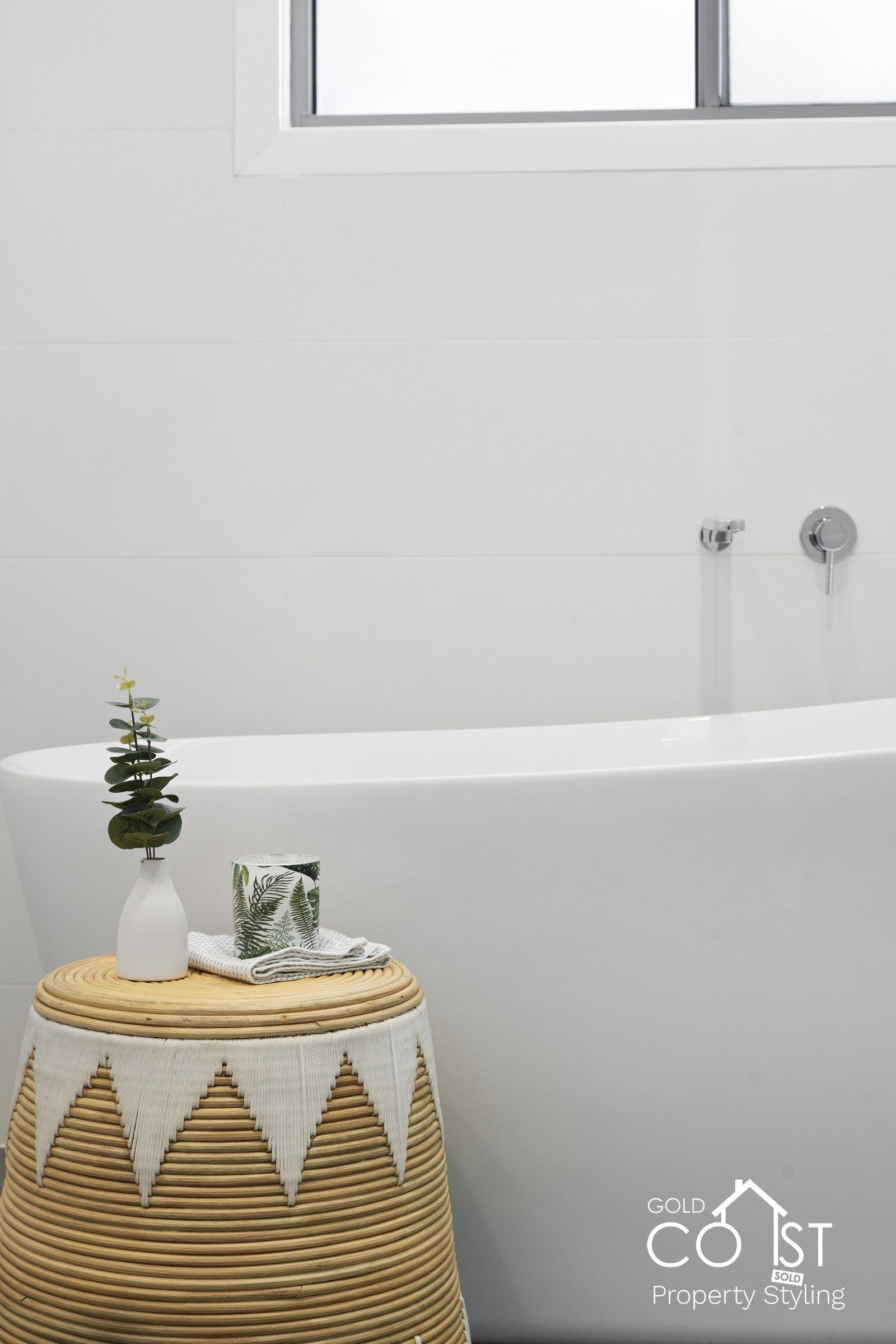 A bathroom with a bathtub and a wicker basket.