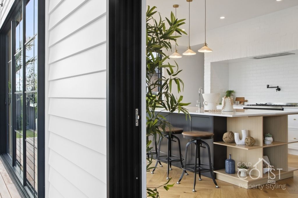 A kitchen with a sliding glass door leading to it.