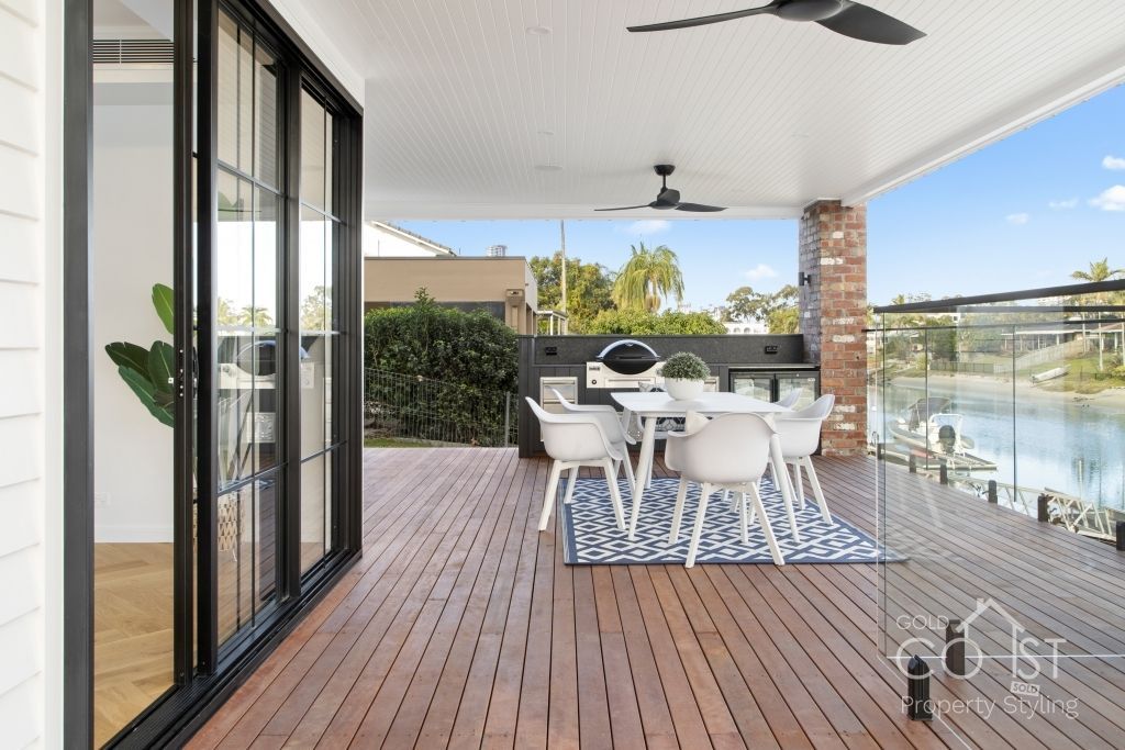 A deck with a table and chairs and a ceiling fan