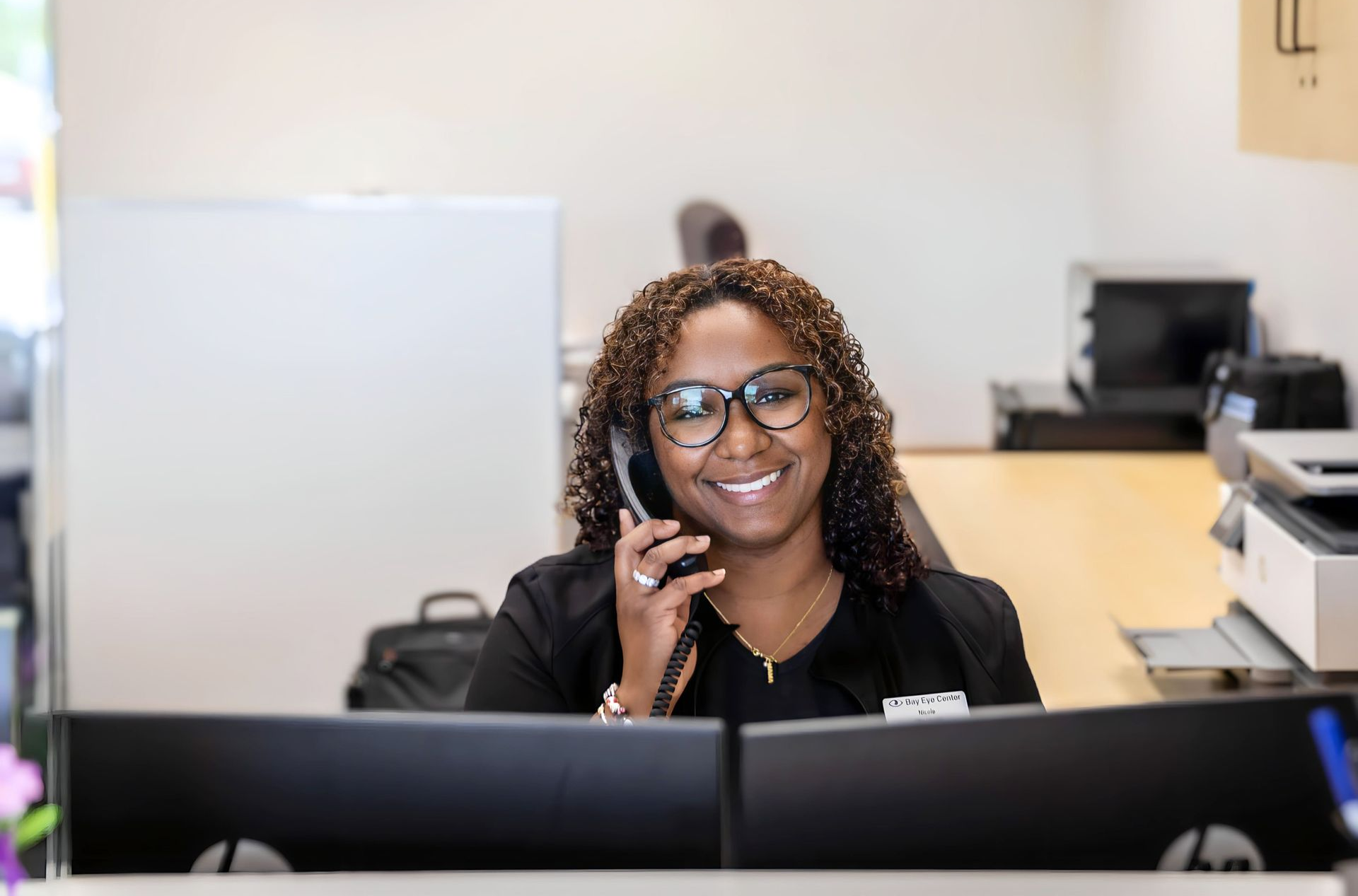 Bay Eye Center team member assisting a caller at the Easton front desk