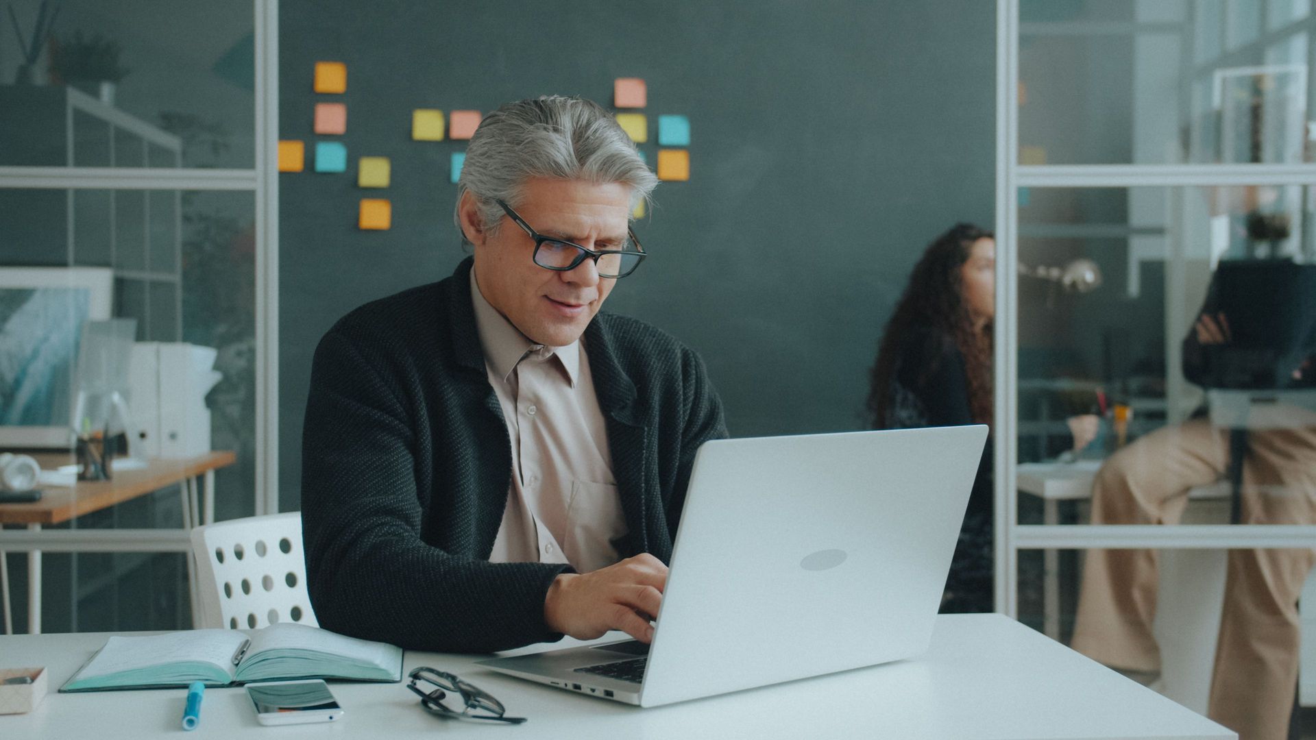 Employer processing staff super payments on his laptop