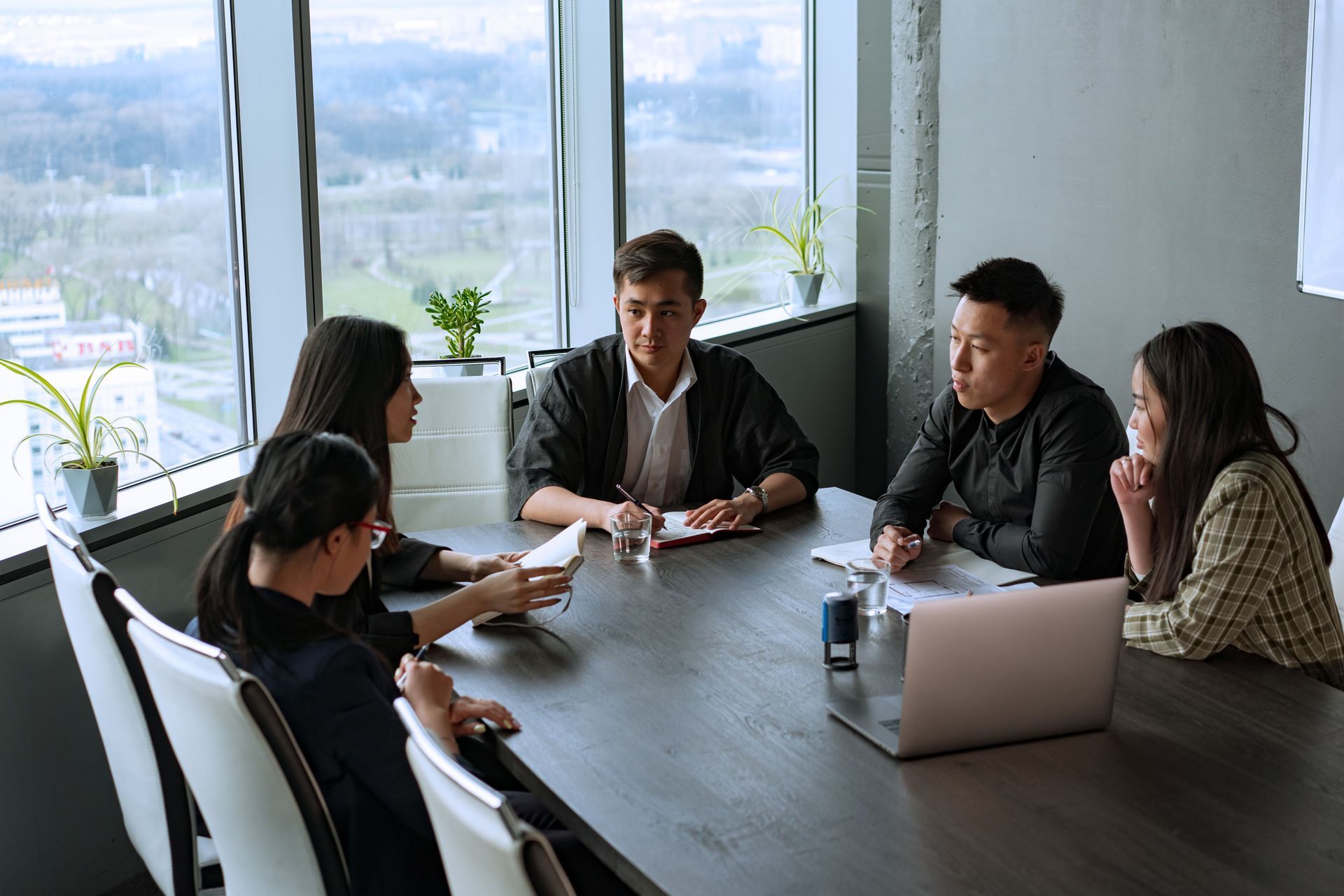 Owners of related businesses meeting around a boardroom table
