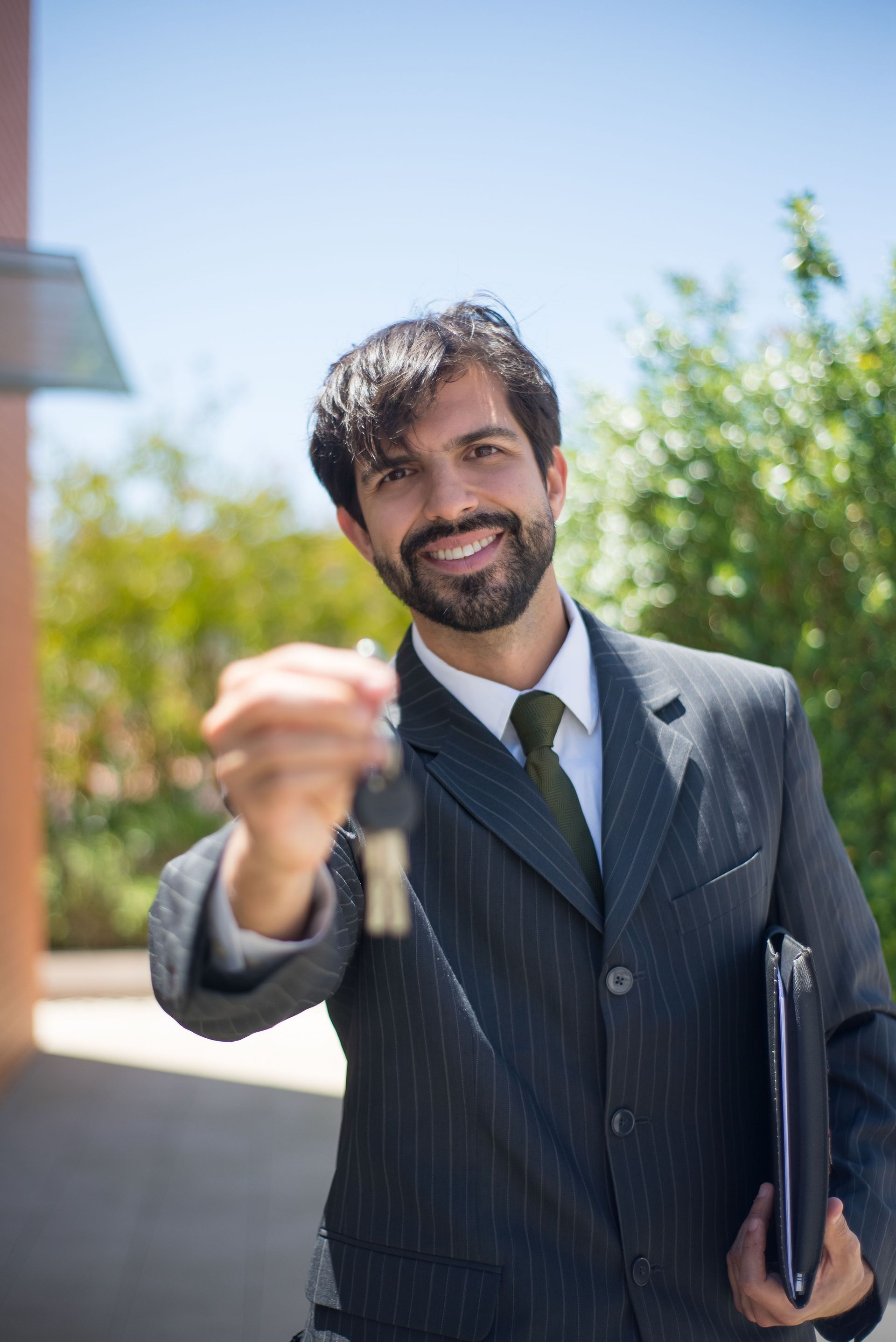 Business owner holding the keys to a new company car