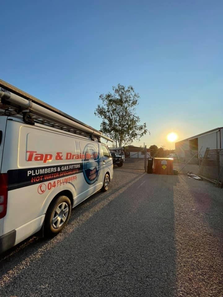 Truck and crane servicing a large tanker in a wooded roadside work area — Tap & Drain Doctor NT in Winnellie, NT