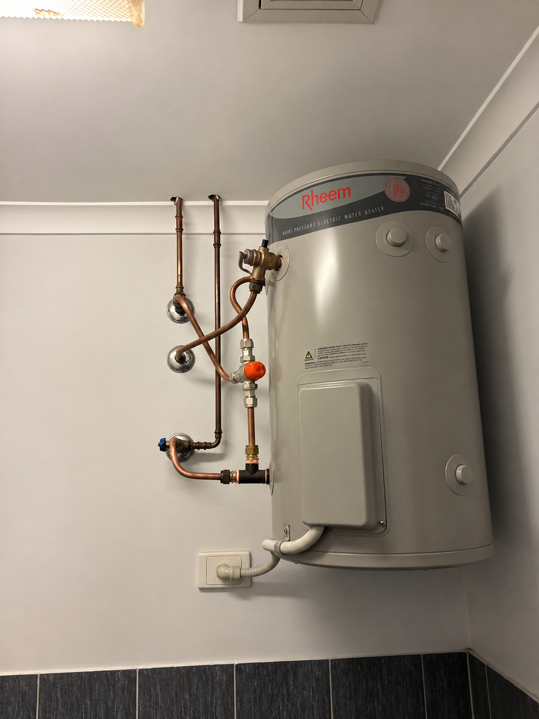 Wall-mounted water heater with exposed copper pipes — Tap & Drain Doctor NT in Winnellie, NT