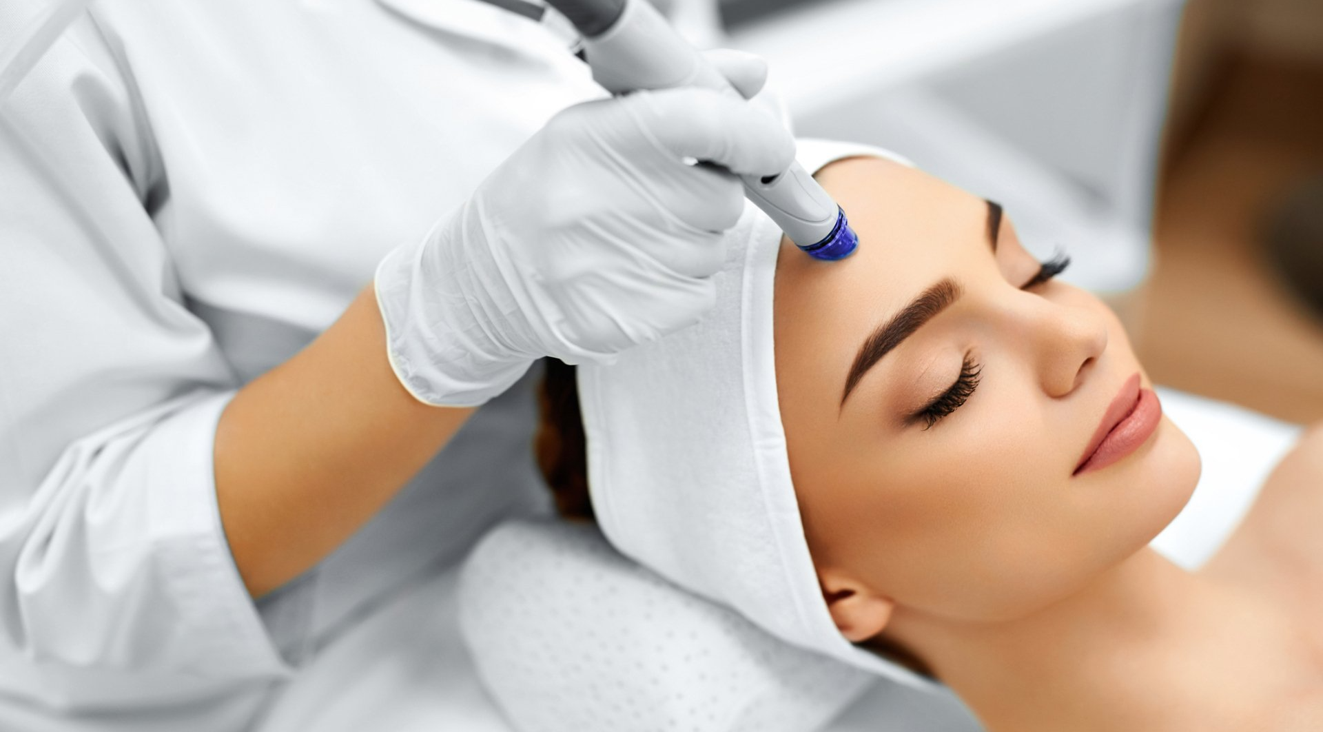 young woman receiving laser treatment for the skin