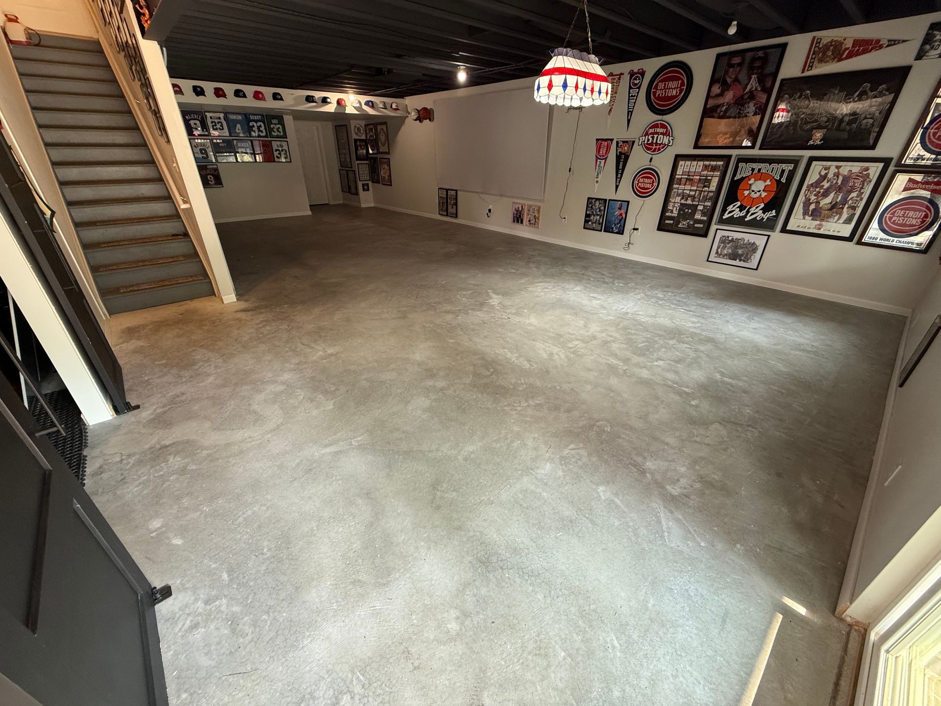 A dirty floor with a staircase in the background.