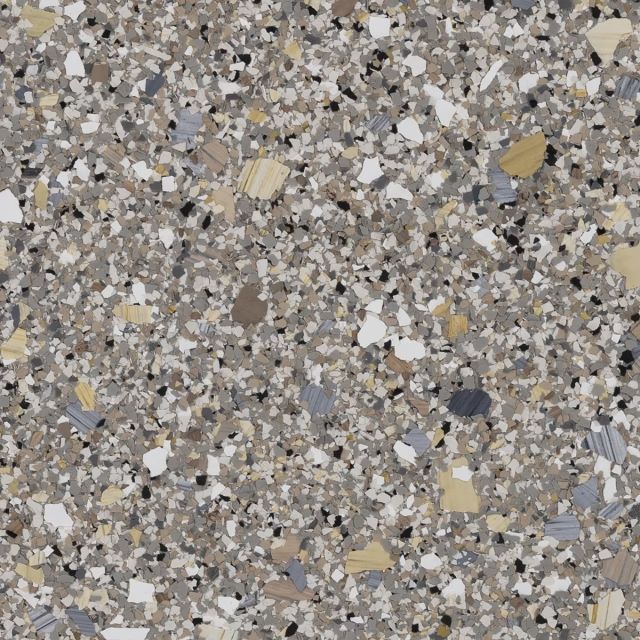 A close up of a floor with a lot of small stones on it.