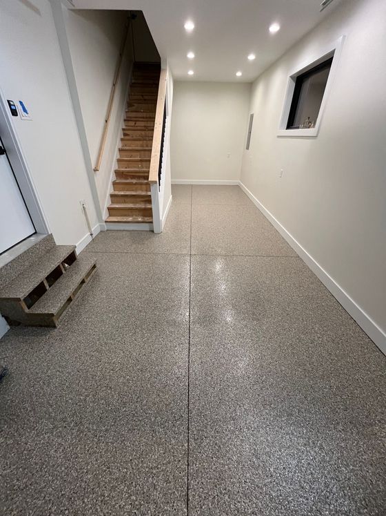 A hallway with stairs leading up to the second floor of a house.