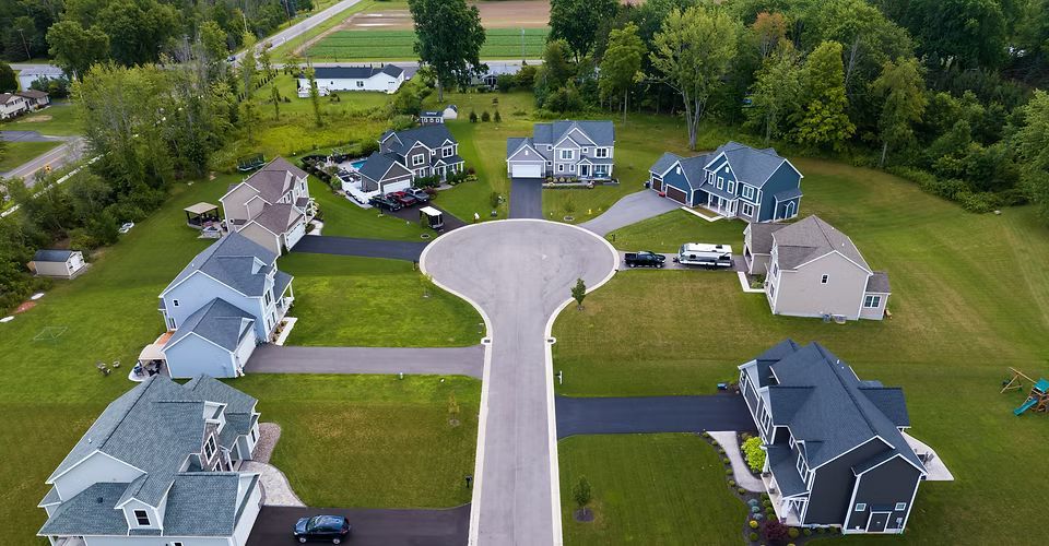 An aerial view of a residential neighborhood with lots of houses and trees.