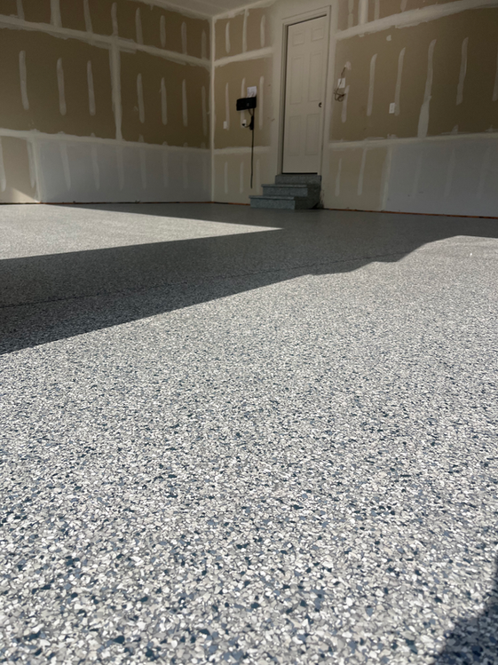 A garage with a concrete floor and a door.
