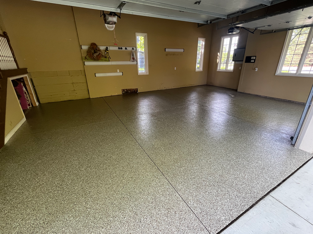 A garage with a concrete floor and a ceiling fan.