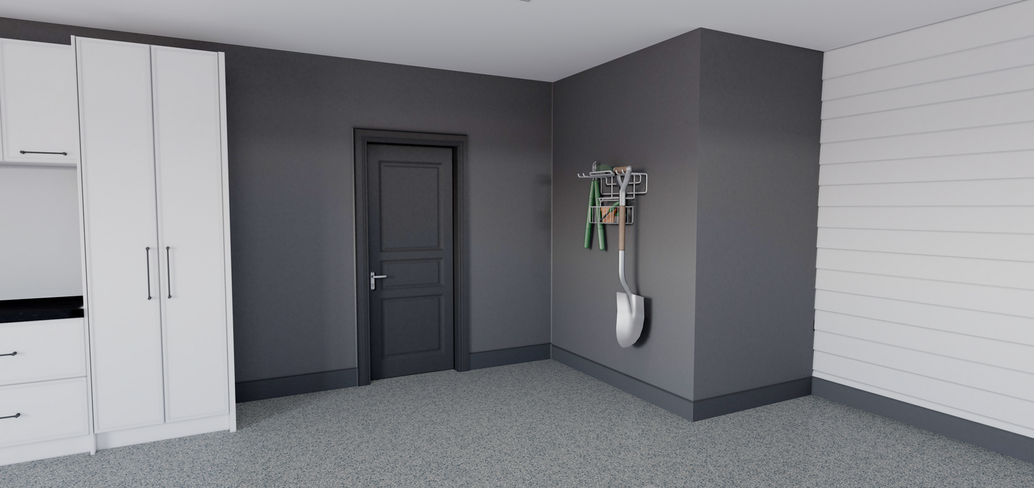 A room with a door and a shovel hanging on the wall.