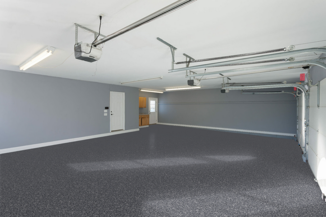 An empty garage with a garage door open and a ceiling lift.