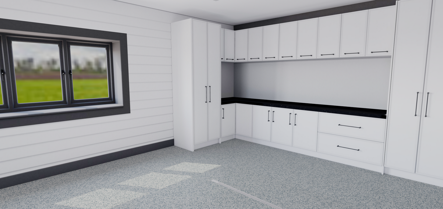 An empty room with white cabinets and drawers and a window.