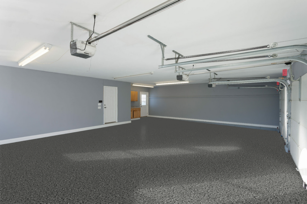 An empty garage with a garage door opener hanging from the ceiling.
