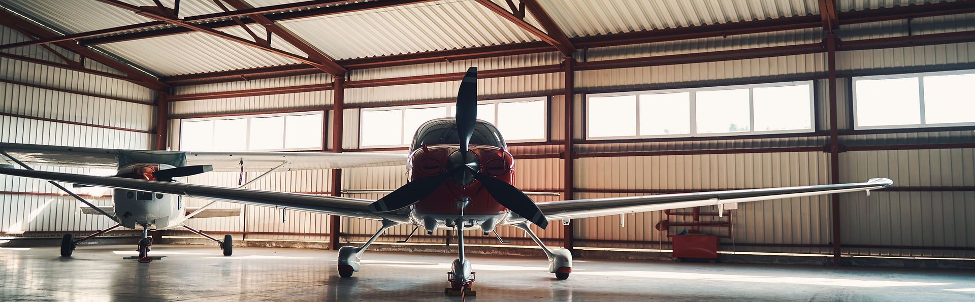 A small propeller plane is parked in a hangar.