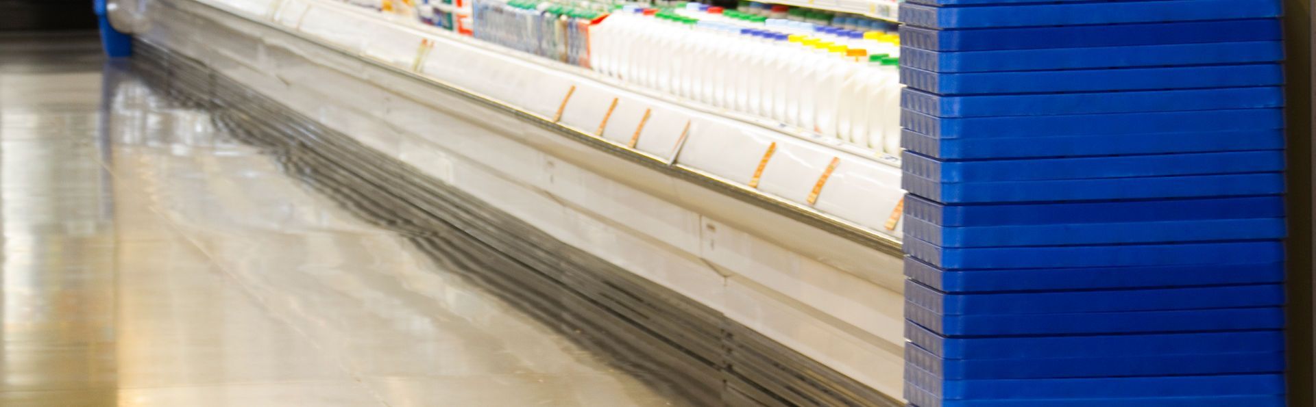 A row of shelves in a grocery store with a blue border.