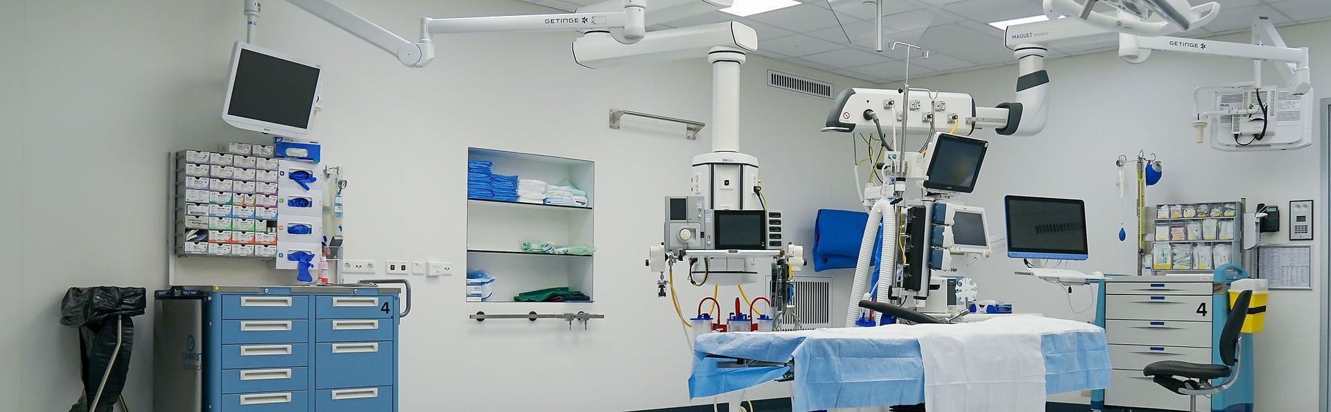 An empty operating room in a hospital with a table and chairs.