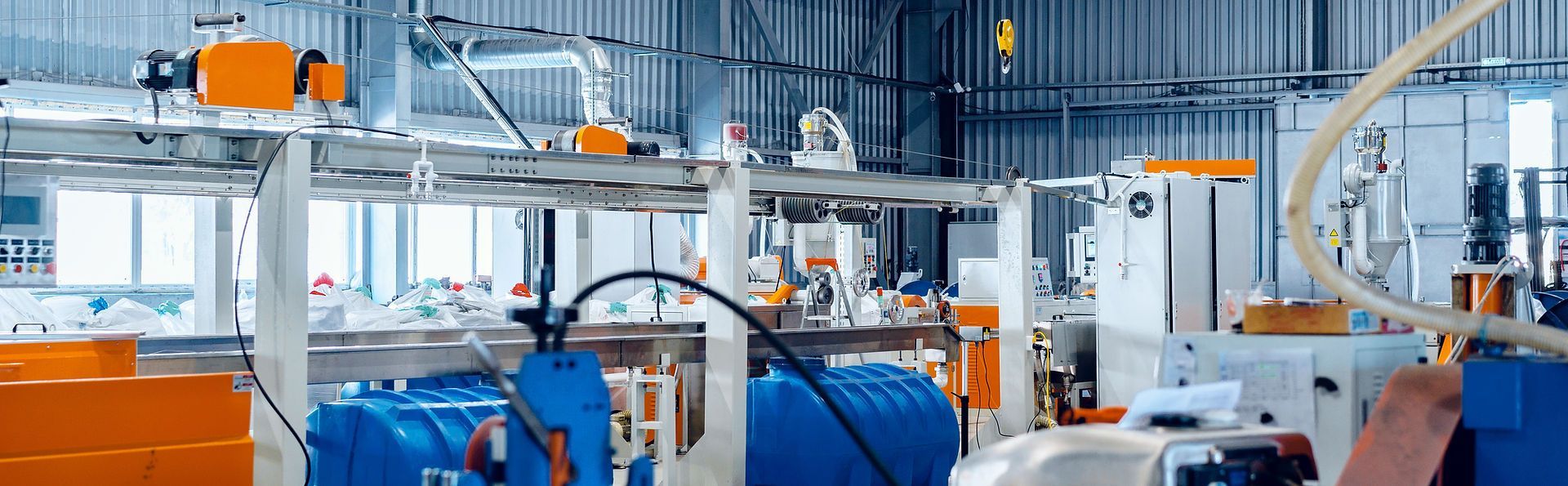 A man is working on a machine in a factory.