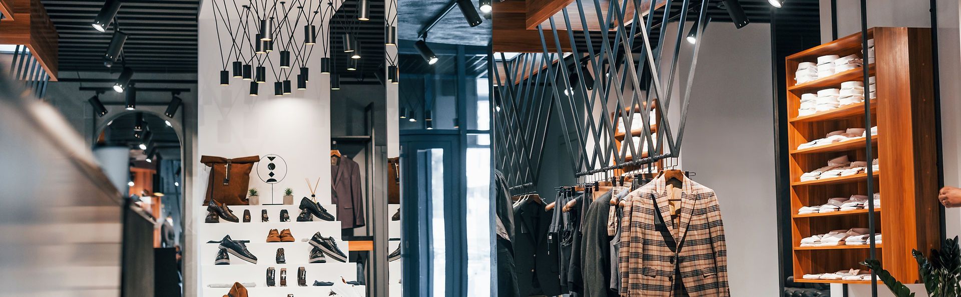 A clothing store with a lot of clothes hanging on racks.