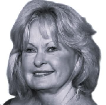 Smiling black-and-white portrait of a woman with shoulder-length hair