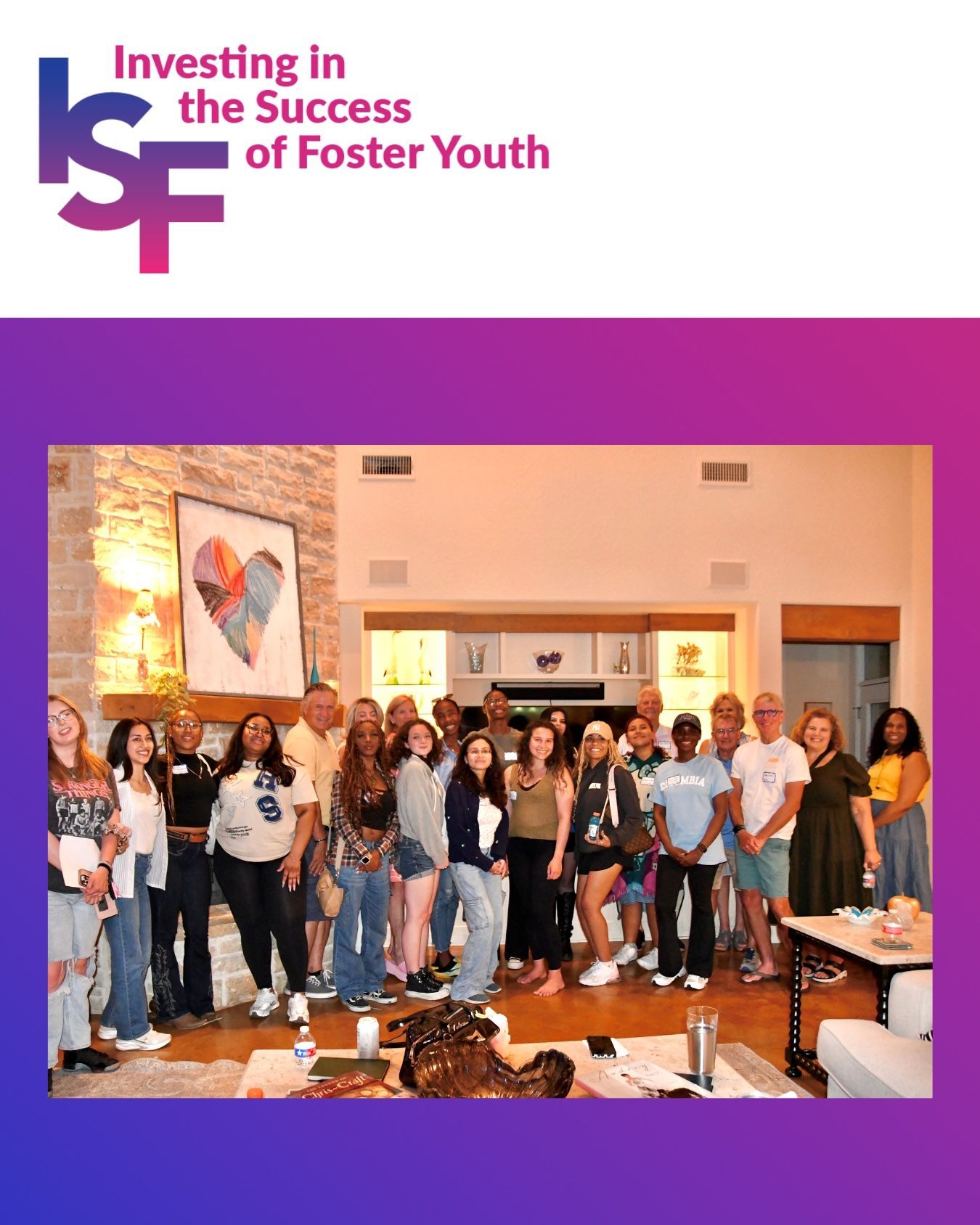 Group of people standing in a hall beneath an “Investing in the Success of Foster Youth” banner