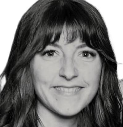 Black-and-white headshot of a smiling person with long dark hair and bangs