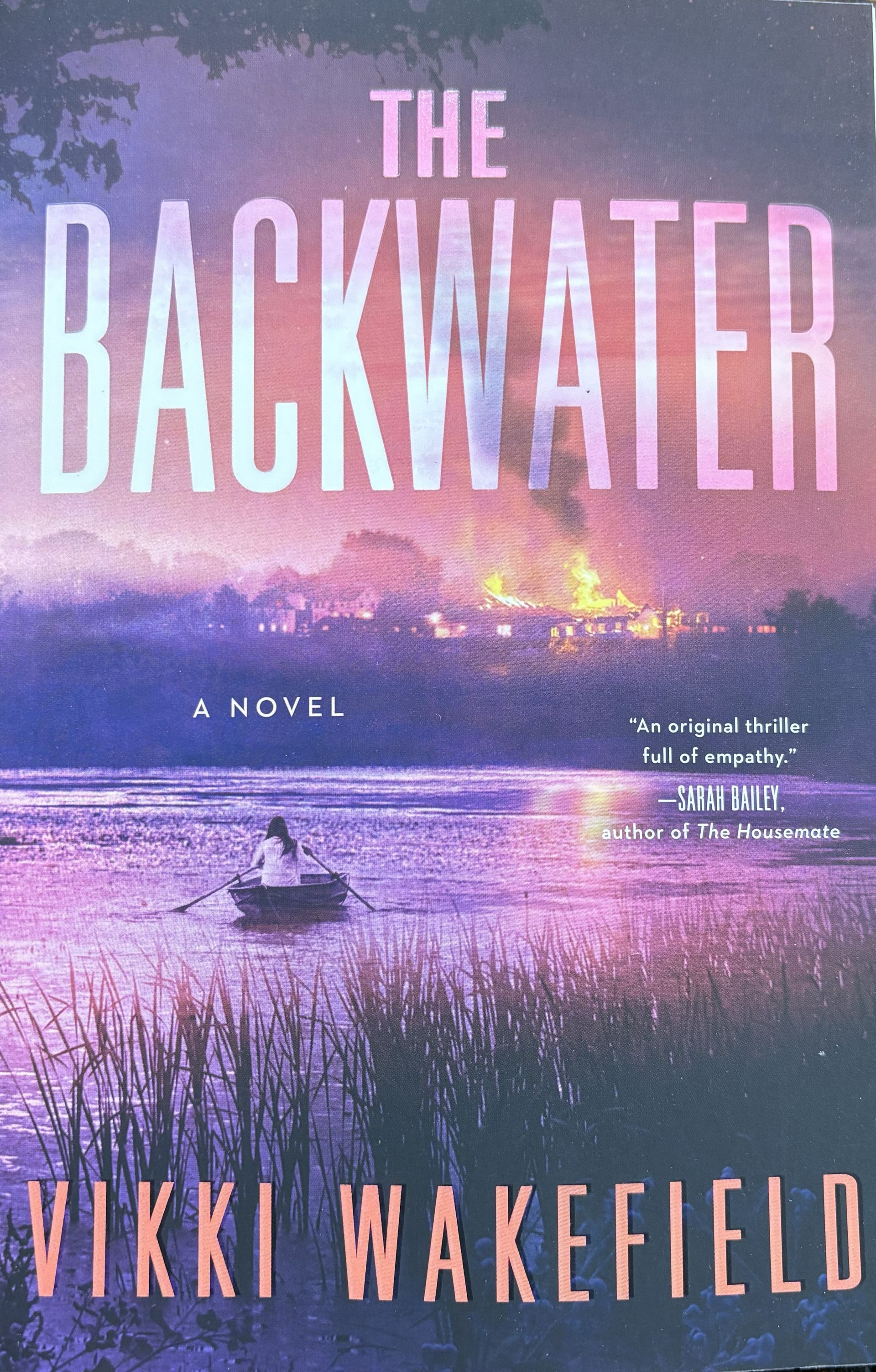 Cover shows a woman in canoe with pink and purple background. "The Backwater" by Vikki Wakefield.