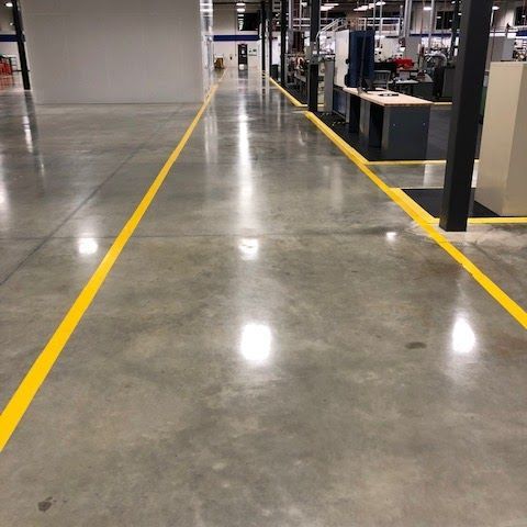 A warehouse with a yellow line on the floor.