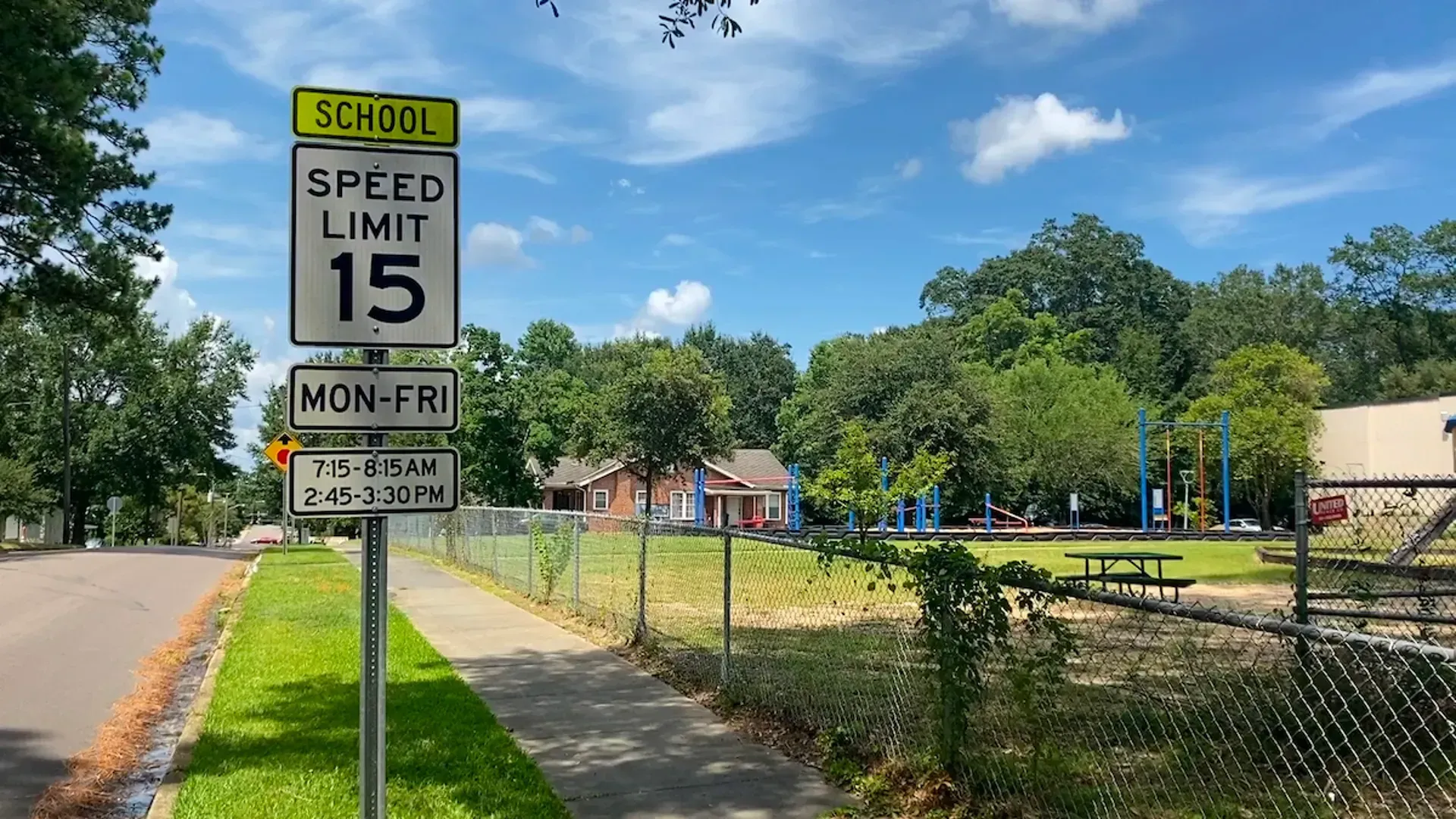 School zone speed limit sign next to playground