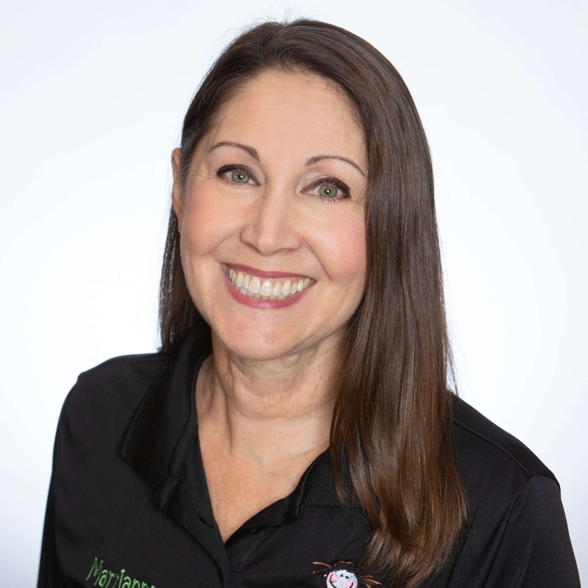 A woman in a black shirt is smiling for the camera.