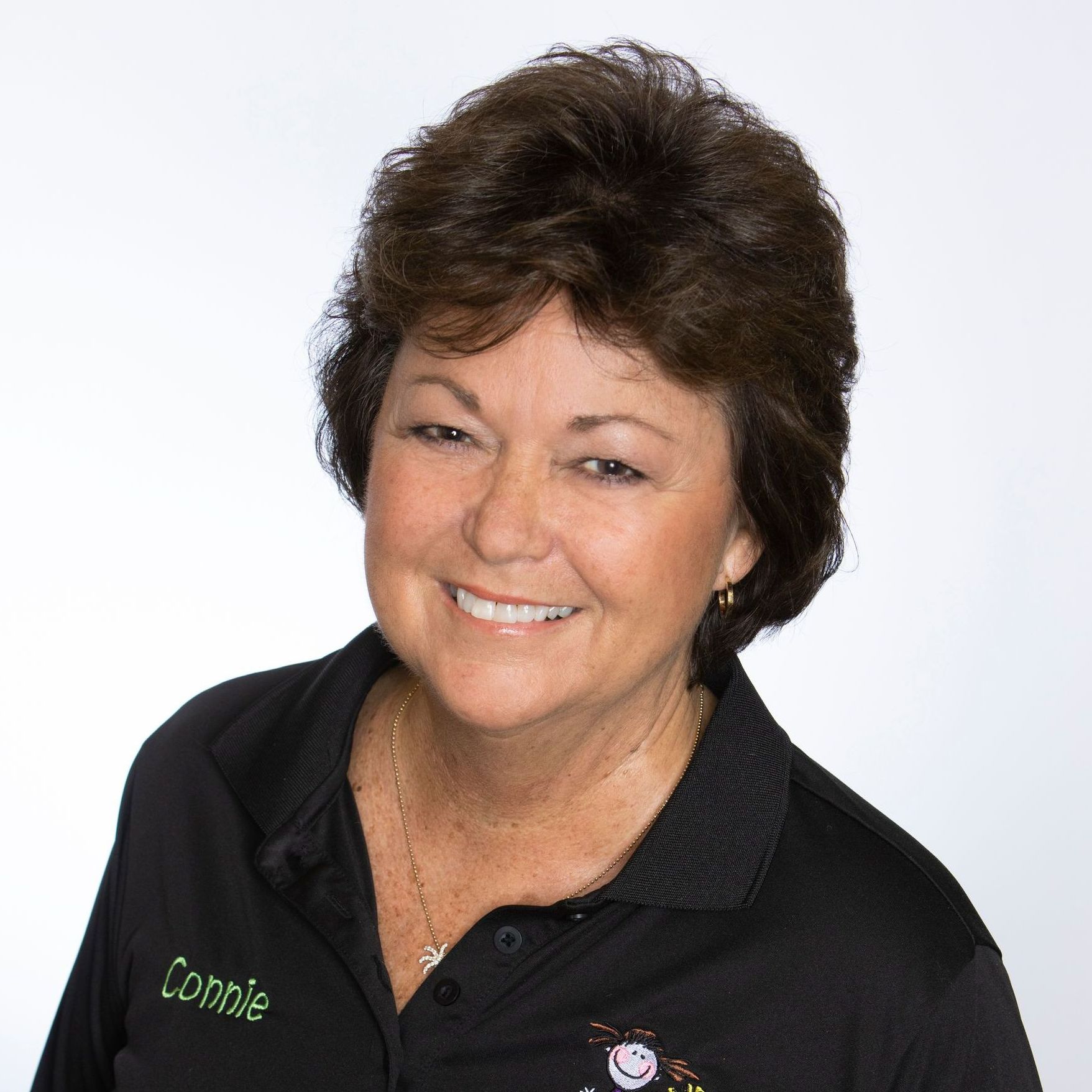 A woman wearing a black shirt with the name connie on it