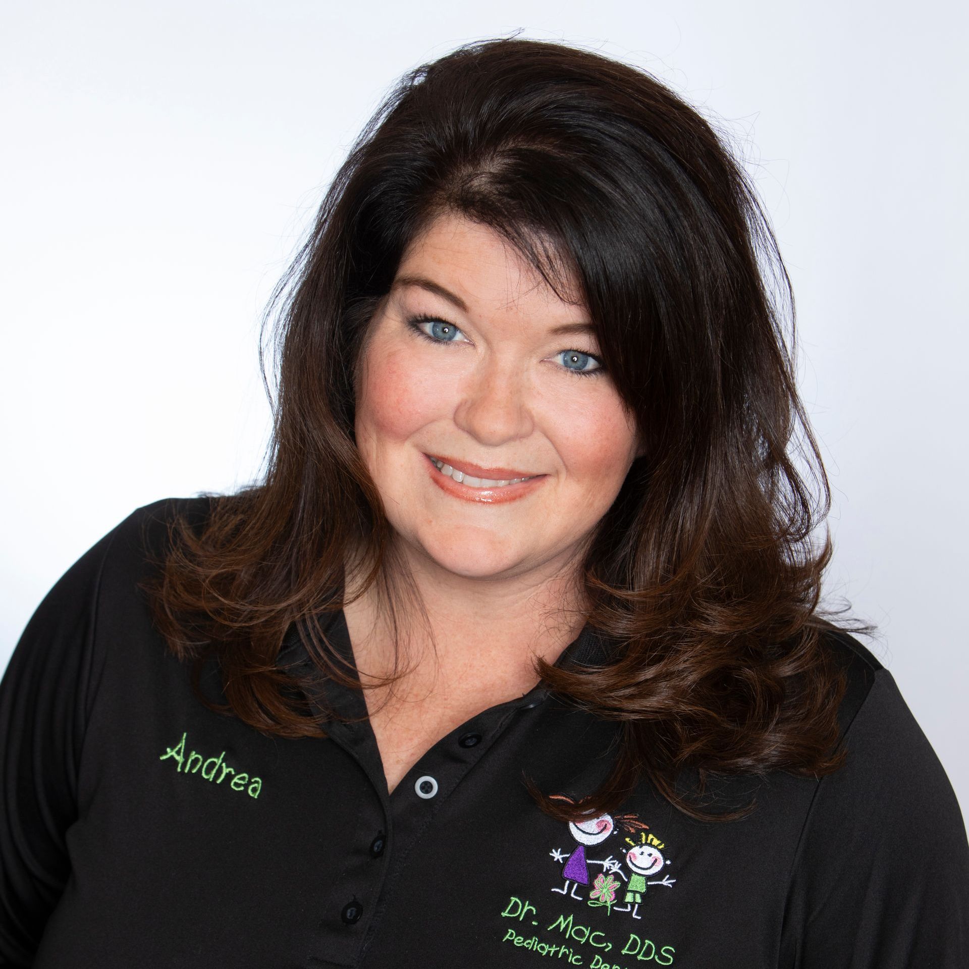 A woman wearing a black shirt with the name andrea on it