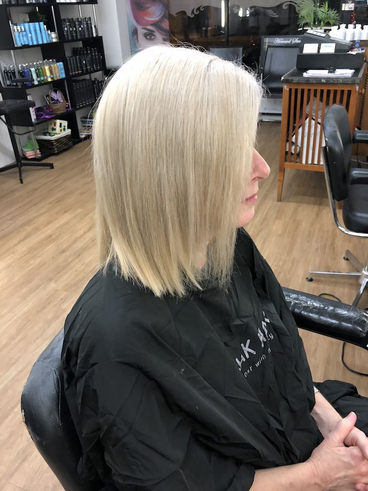 A Woman With Blonde Hair Is Sitting In A Chair In A Salon — Howard Street Hair Studio In Nambour, QLD