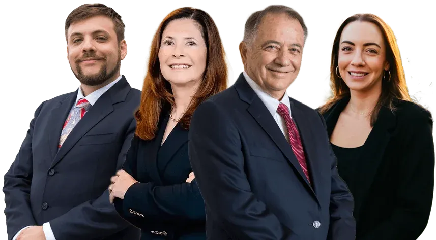 Four professionally dressed businesspeople standing together against a white background