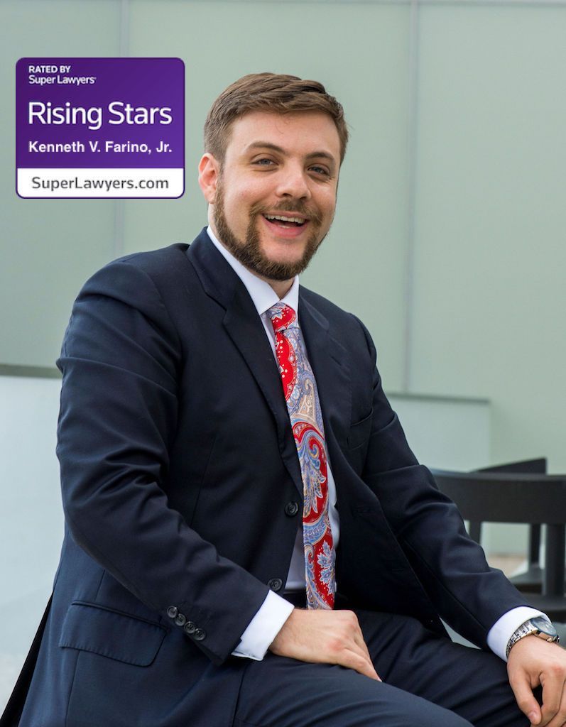 A man in a suit and tie is smiling for the camera