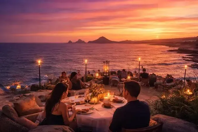 Photorealistic friends sharing a relaxed dinner on a Los Cabos vacation rental terrace at sunset