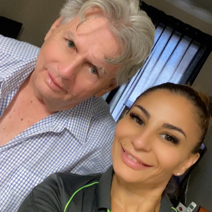 A man and a woman are posing for a picture together