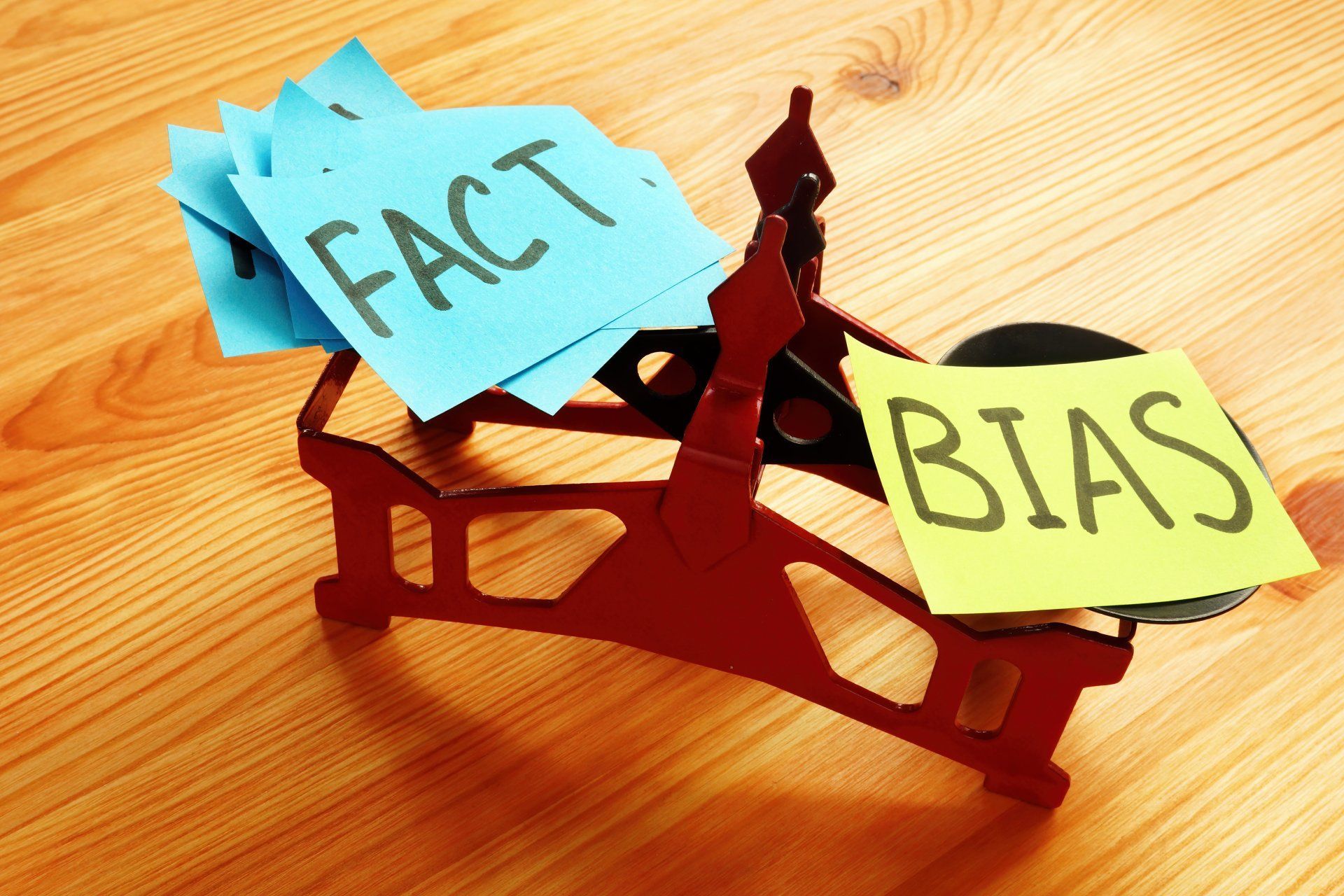 A scale with a sticky note that says bias on it