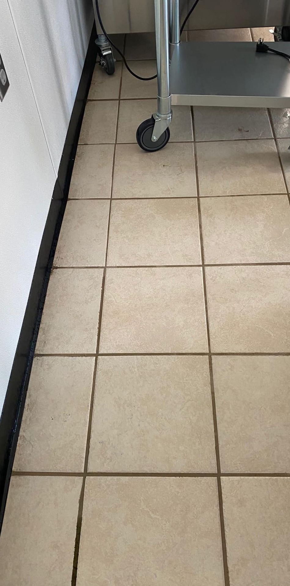A close up of a tiled floor with a cart in the background.