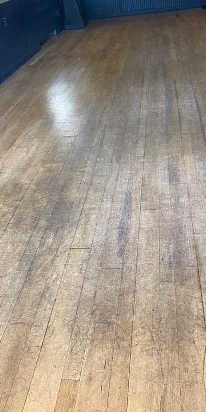 A close up of a wooden floor in a room.
