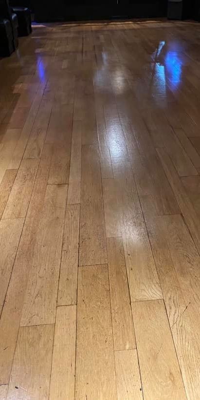 A close up of a wooden floor in a room.