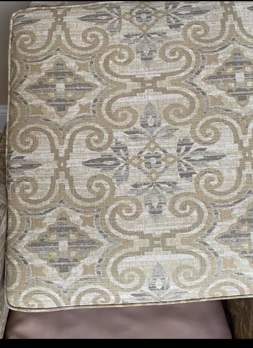 A close up of a chair with a pattern on it.