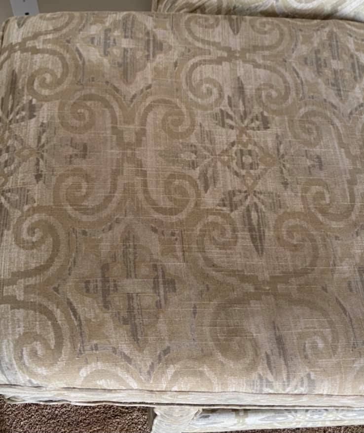 A close up of a chair cushion with a pattern on it.