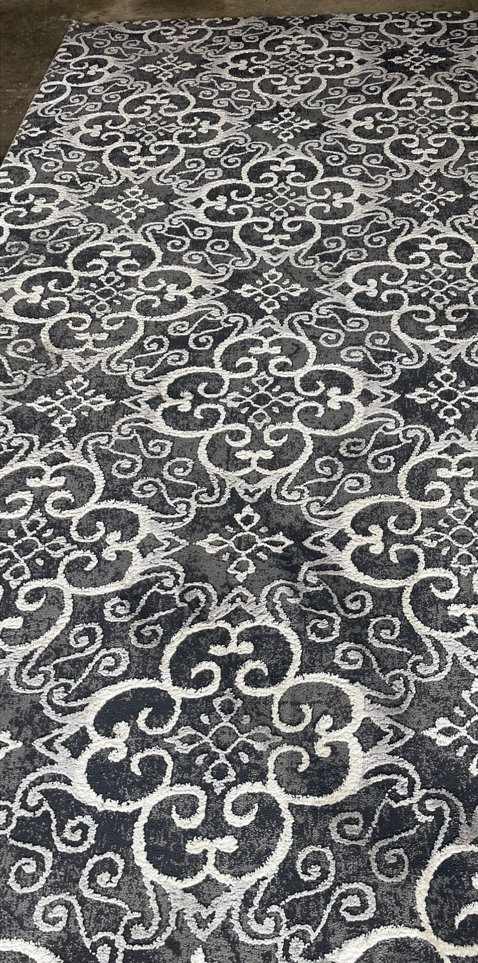 A black and white rug with a floral pattern on it.